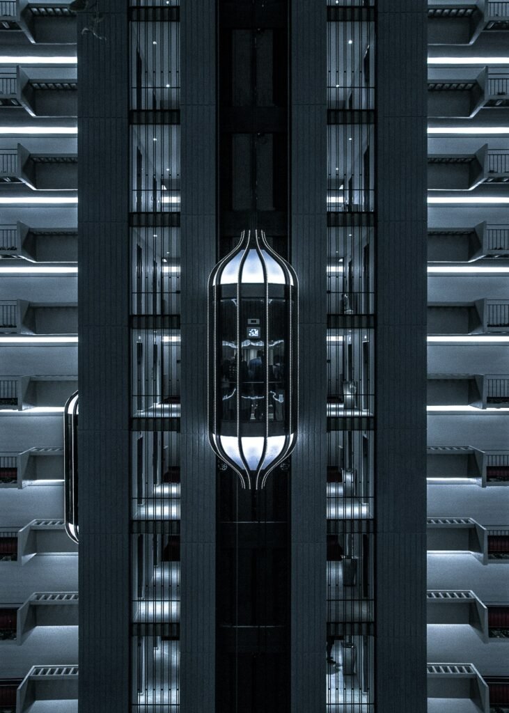 Futuristic Capsule Elevator with Pod Design in Modern High-Rise Building